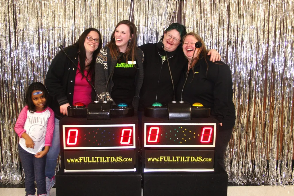Subway corporate event game show with guests at podium buzzers