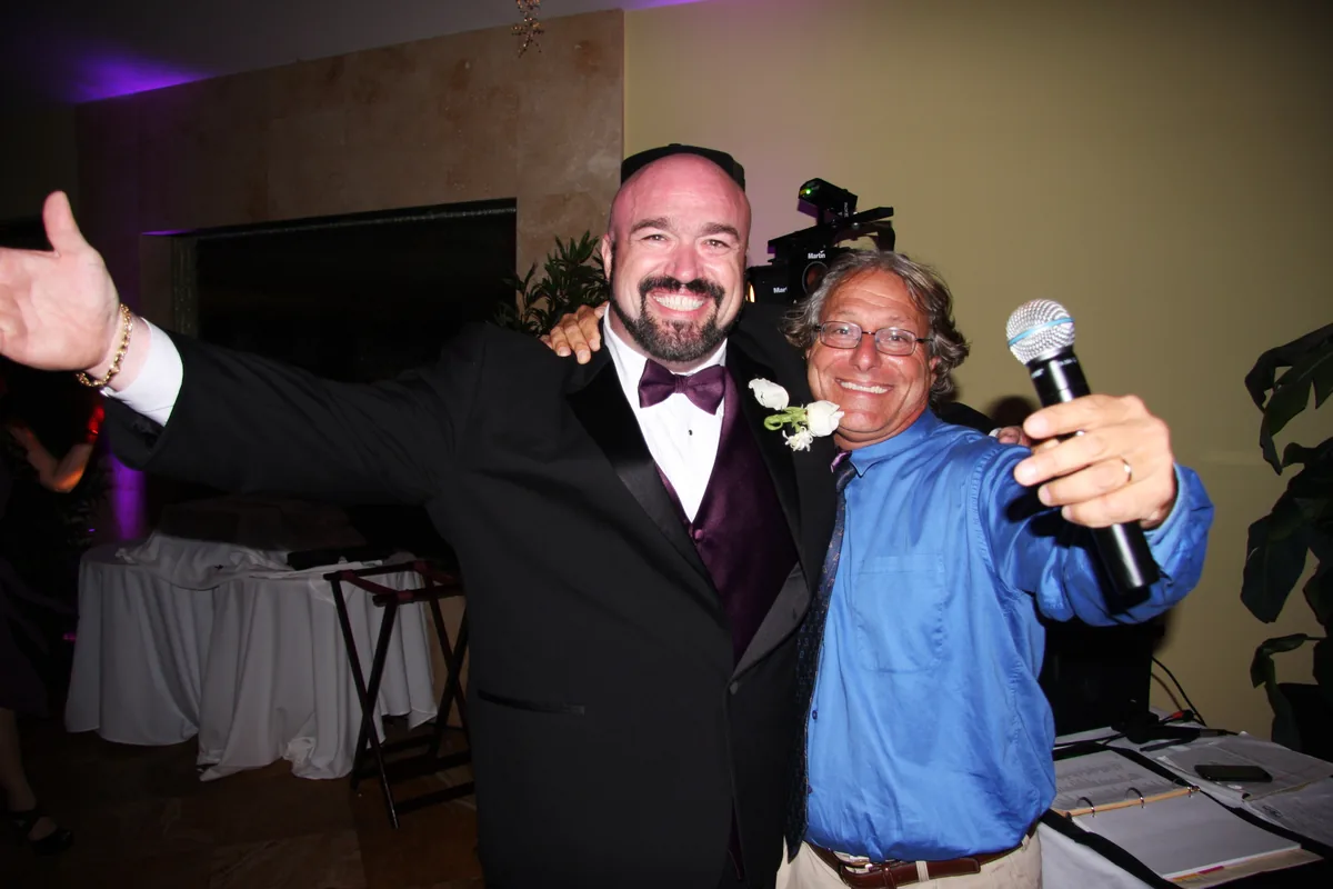 Scott celebrating with Marc Gill at his wedding reception